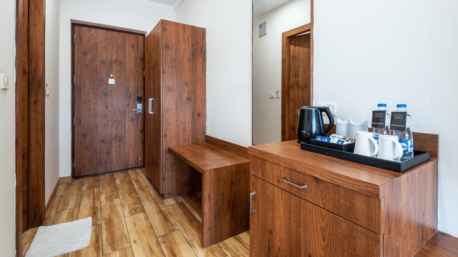 premium room with tea & coffee maker and a wooden wardrobe at DLS The Classio